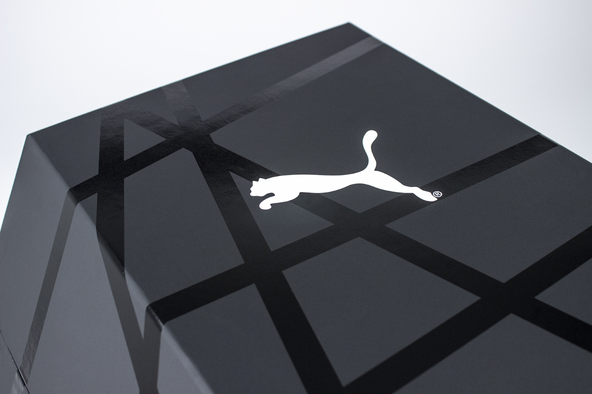 PUMA golf influencer kit showing hexagonal box with white PUMA logo on matte black background