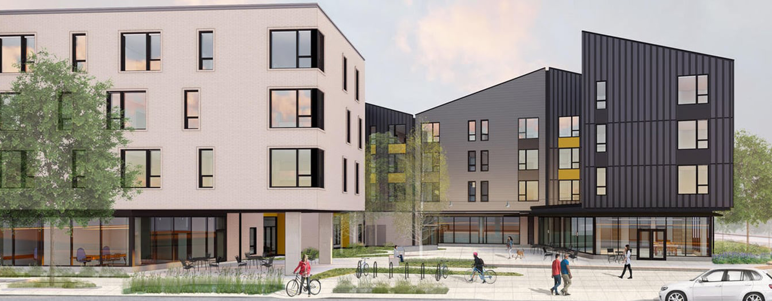 Renaissance Commons buildings with people and cars and bicyclists in front of them