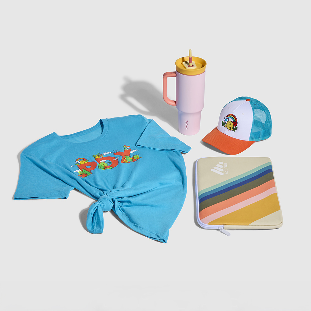 Colorful array of branded promotional materials including a thermos, tee shirt, laptop sleeve, and ball cap.