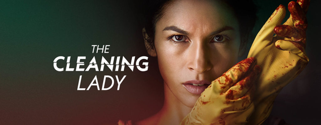 The Cleaning Lady press kit image featuring a woman taking off yellow cleaning gloves speckled with blood