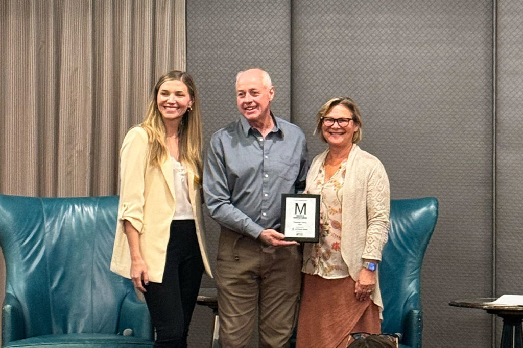 Juli Cordill and Chris Feryn of Premier Press accepting the Portland Business Journal’s 2024 Makers & Manufacturers Award presented to Premier Press