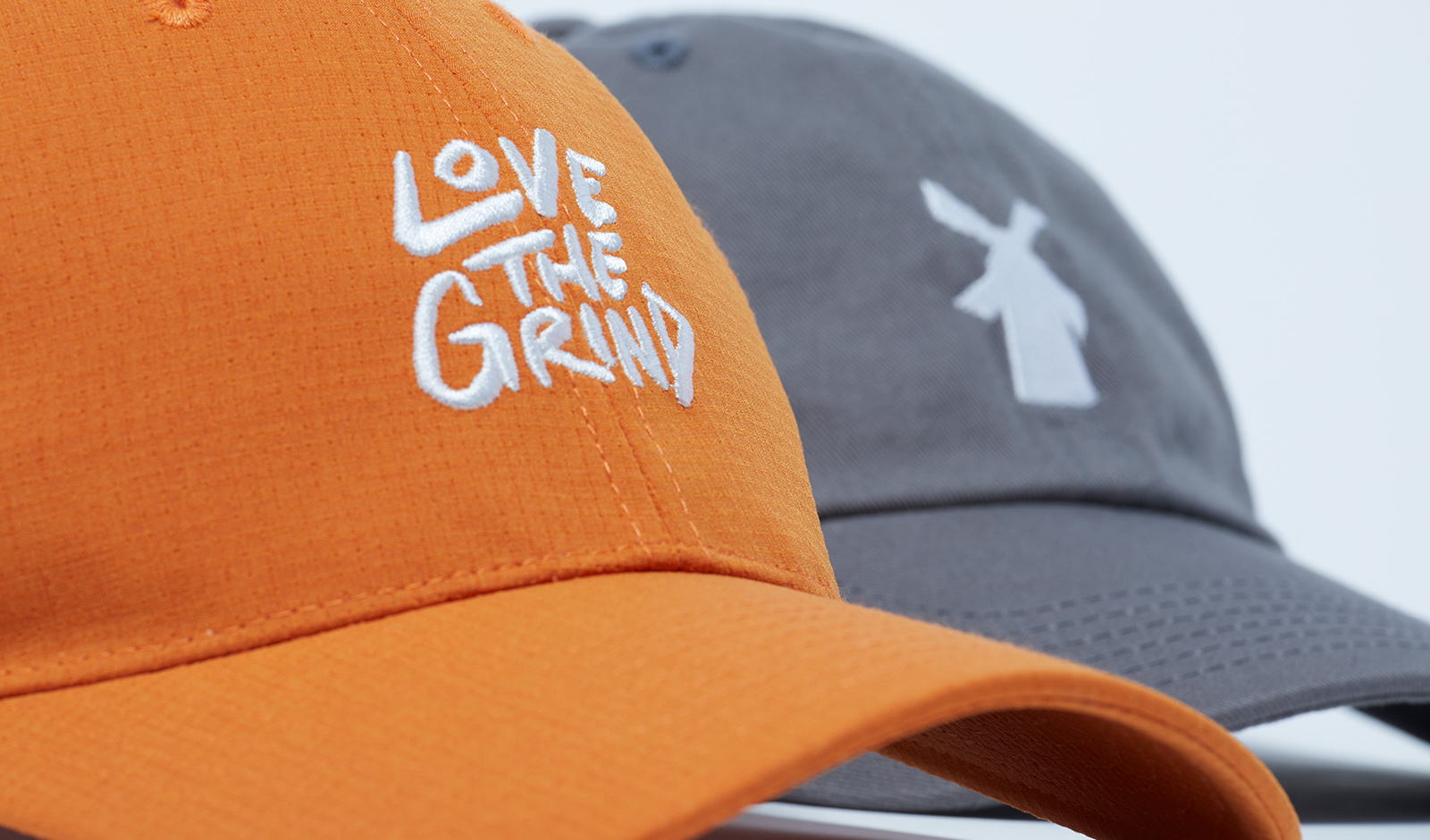 Dutch Bros "Love the Grind" hats in orange and grey