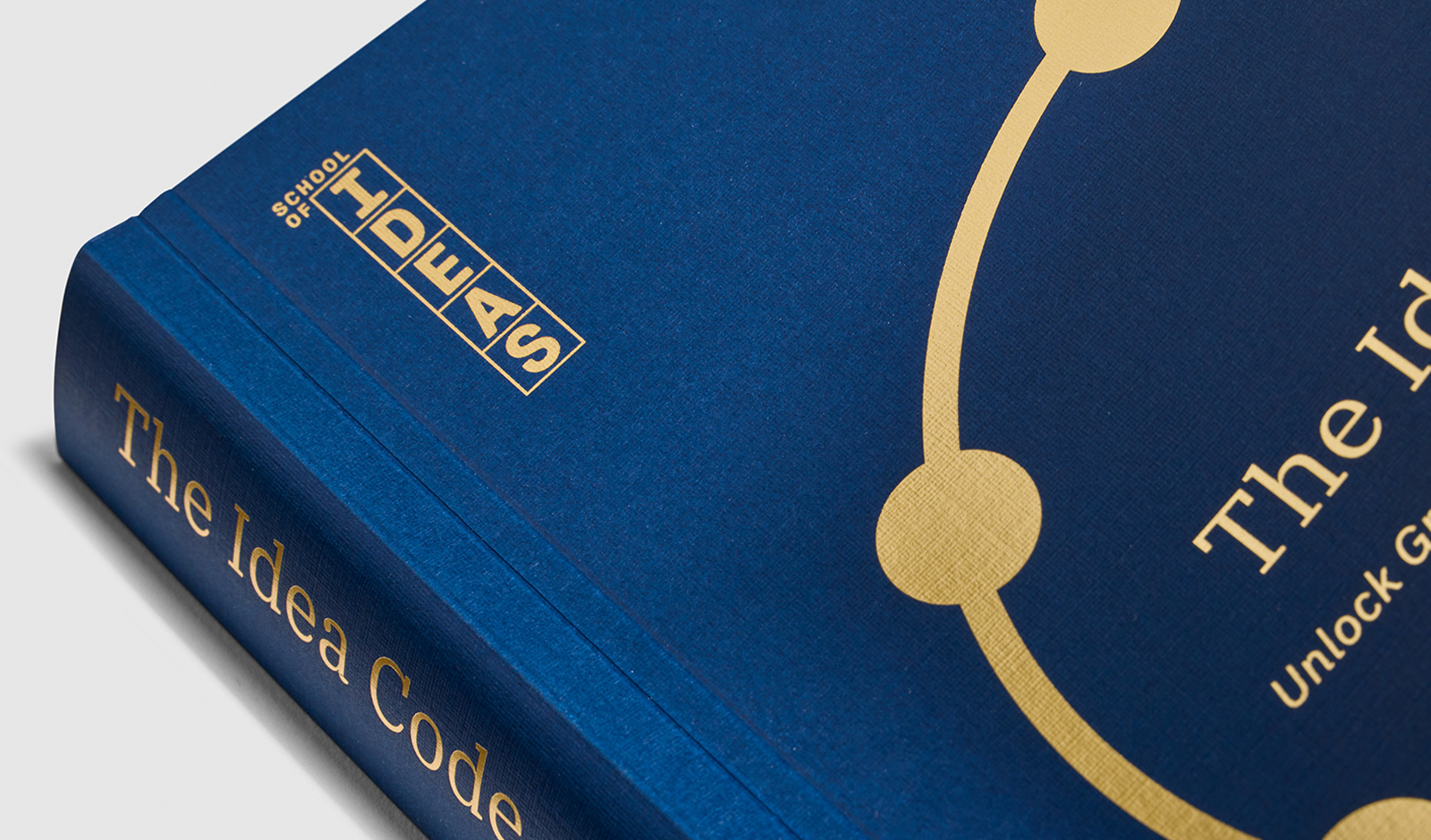 School of Ideas blue book with gold print