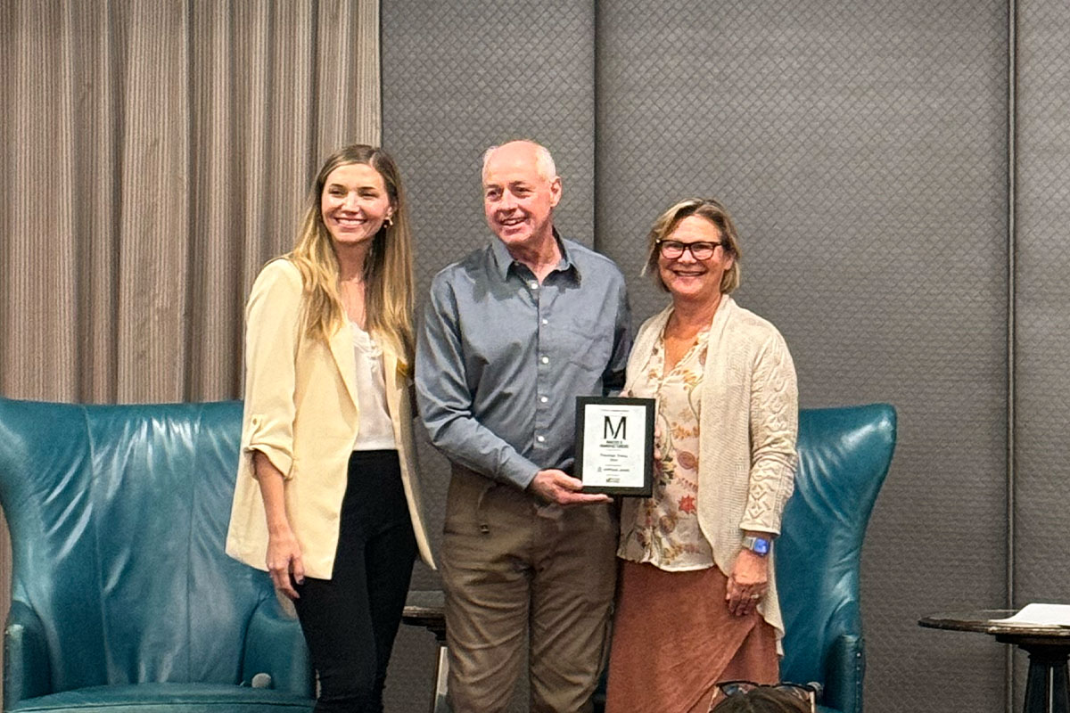 Juli Cordill and Chris Feryn of Premier Press accepting the Portland Business Journal’s 2024 Makers & Manufacturers Award presented to Premier Press